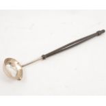 A silver punch ladle with wooden handle.