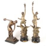 A bronze model of the discus thrower and pair of spelter figures.