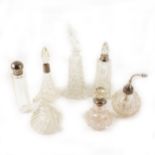 A collection of glass scent bottles and atomisers, many silver or metal mounted.
