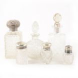 Four silver capped scent bottles and two glass scent bottles.