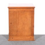 A mahogany table top stationery cabinet