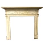 An Edwardian painted pine fire surround, in the Adam style