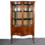 An Edwardian mahogany serpentine china cabinet