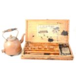 A set of wooden printing blocks and a copper electric kettle.