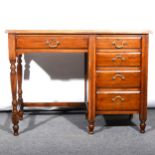 An Edwardian stained walnut single pedestal desk