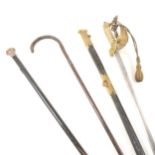 A Royal Naval officer's sword, a walking stick, and a silver-capped cane