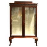 A stained mahogany display cabinet