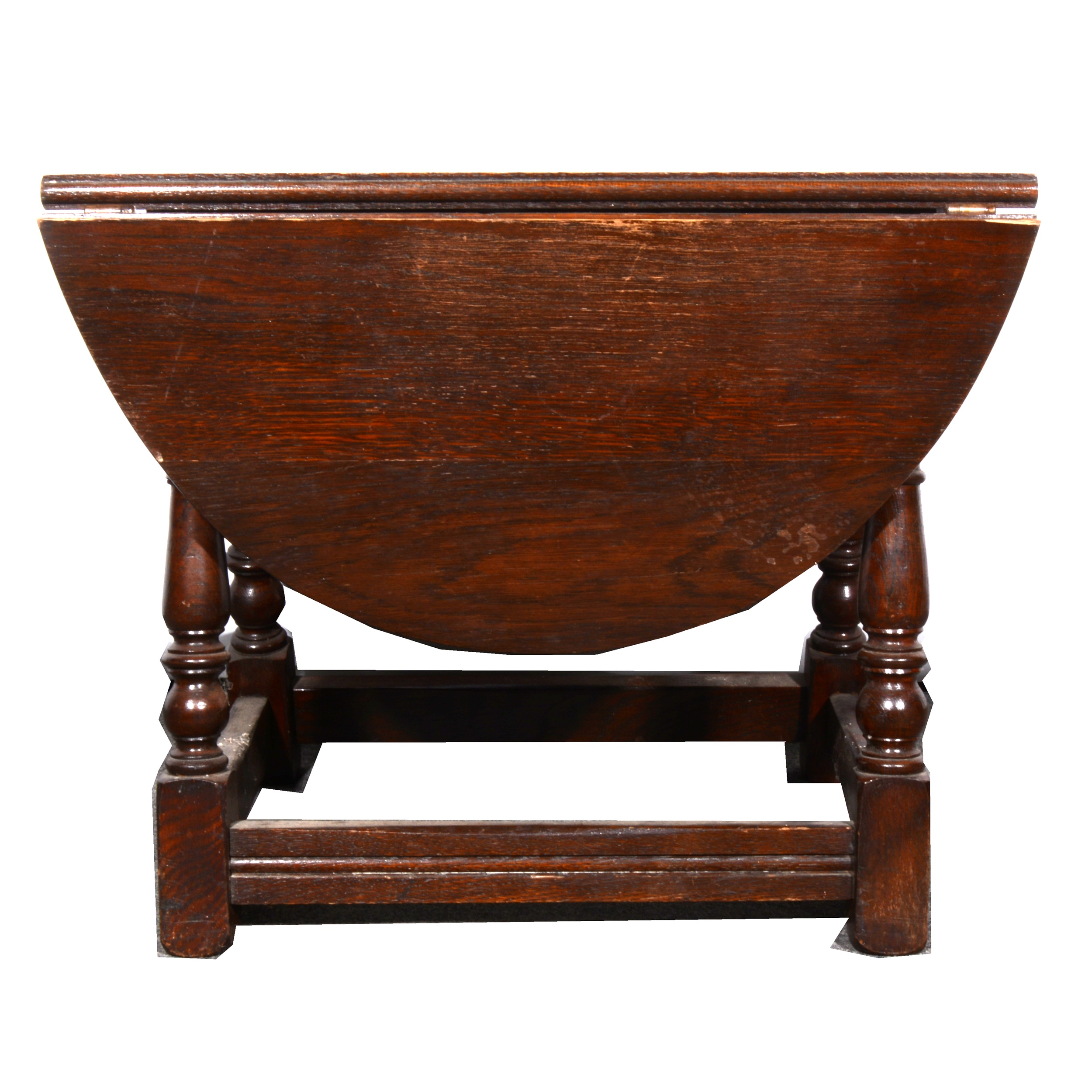 A stained oak circular dropleaf occasional table