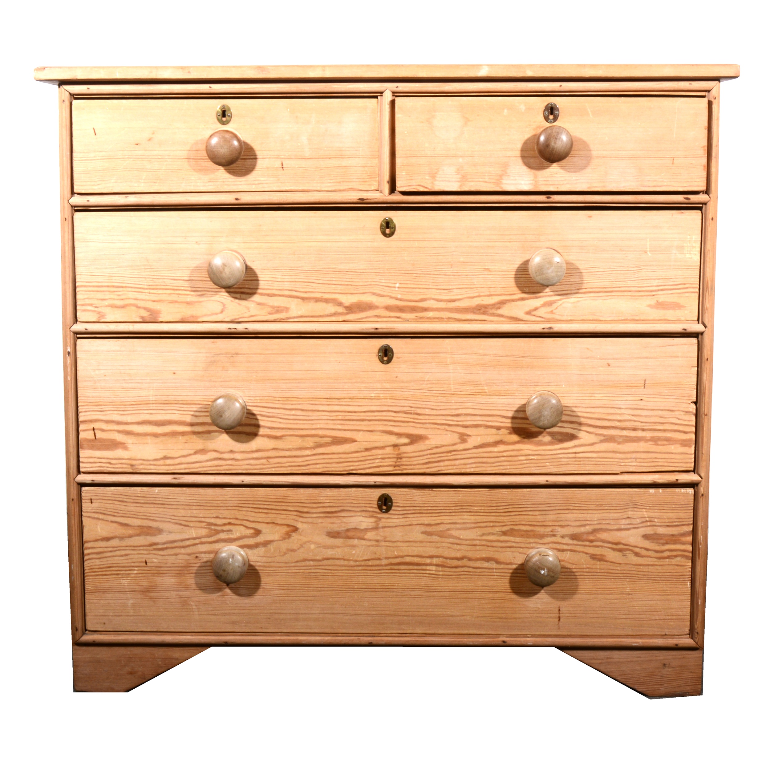 A stripped pine chest of drawers