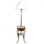An Edwardian brass patent lamp table, adjustable column, the table top outlines in stained walnut on