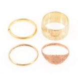 A 9 carat yellow gold wedding band, two 22ct bands, and a 9ct signet ring