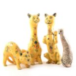 Three Continental faience figures of cats, and another pottery model