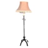 A wrought iron standard lamp, candle fitment, complete with shade, 163cm overall.