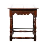A Victorian carved oak lamp table