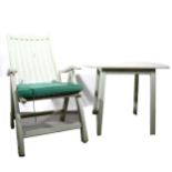 A painted teak folding garden chair, and a similar garden table