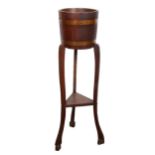 An oak jardiniere stand, barrel-like, tripod base, 95cm.