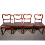 A set of four Victorian mahogany hoop-back dining chairs, loose-fitting seats, octagonal tapering