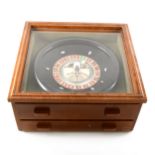 A stained wood table-top Roulette set