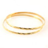 Two yellow metal slave bangles stamped "18ct"