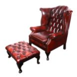 A traditional wing-back easy chair, upholstered in buttoned Club Red leather, width 82cm; and a