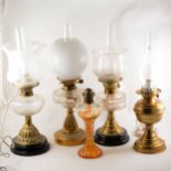 A brass oil lamp and four others
