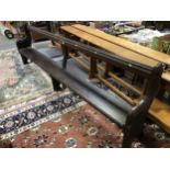 A Victorian stained pine long pew, moulded rail over open back, shaped ends, single board seat,