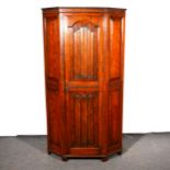 An oak hall robe, canted form, doors with linen-fold panels, with 96cm, height 176cm.