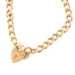 A 9 carat yellow gold solid curb link charm bracelet with padlock fastener.