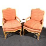 A pair of Louis XV style painted beech bergere chairs
