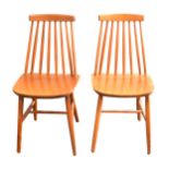 A pair of Ercol stained beech stick back kitchen chairs
