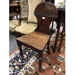 A George IV mahogany hall chair, gadrooned cresting, solid seat, turned legs, 82cm.