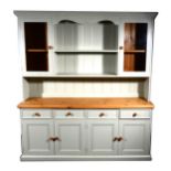 A modern pine and painted kitchen dresser, the upper section with open shelves and glazed panelled
