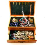 A wooden jewel box of natural stone and freshwater pearl necklaces and bracelets.