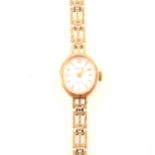 Accurist - a lady's 9 carat yellow gold bracelet watch.