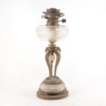 A gilt metal and cut-glass oil lamp, with Griffin head monopods