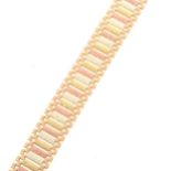 A vintage 9 carat yellow, red and white gold bar link bracelet.