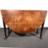 An old oak gateleg dining table, oval top, turned legs, pad feet, 100cm x 140cm.