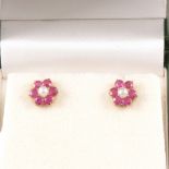 A pair of ruby and pearl cluster ear studs.