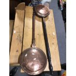 Two Victorian copper warming pans, one with ebonised handle