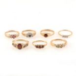 Six 9 carat gemset rings and one marked 18ct.