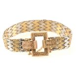 A 9 carat yellow and white gold buckle design bracelet.