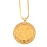 A Mexican 50 Pesos gold coin in a claw set pendant mount on a chain.