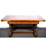 An oak draw-leaf table, diaper inlaid frieze, twin bulbous supports, standard ends, overall length