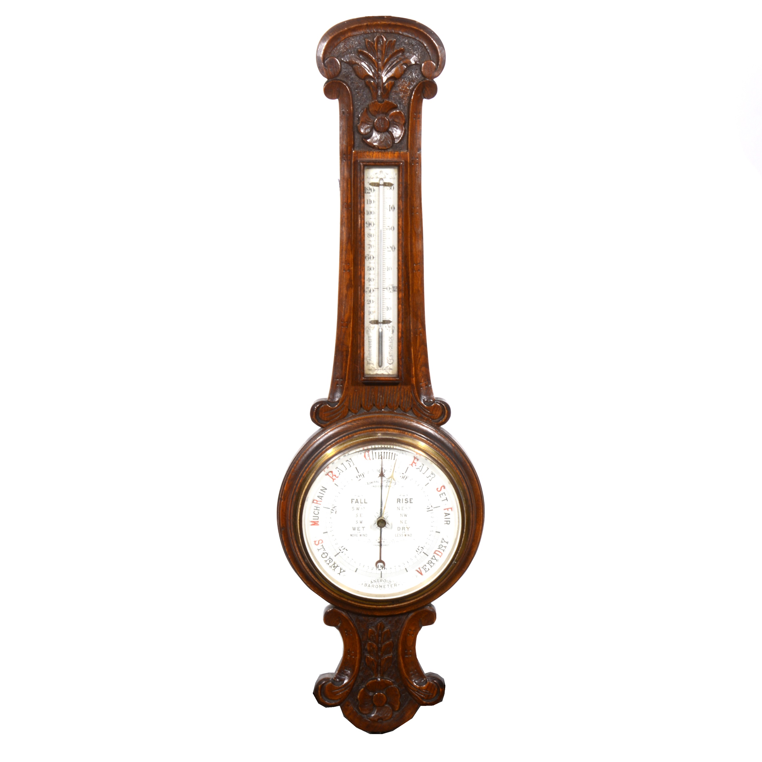 An Edwardian carved oak aneroid wall barometer, banjo shape case, the dial inscribed 'Admiral