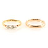 A diamond three stone ring and 9 carat yellow gold wedding band.