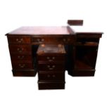 A reproduction mahogany finish twin pedestal desk, with a tooled leather inset, fitted with three