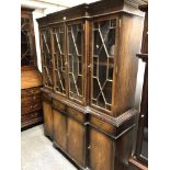 A Georgian style reproduction mahogany finish breakfront bookcase, dentil cornice, astragal glazed