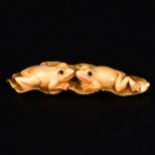 A Japanese carved and stained ivory netsuke, probably early 20th Century