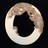 A Japanese carved ivory oval photograph frame, early 20th Century