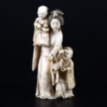 A small Japanese carved and stained ivory group, probably early 20th Century